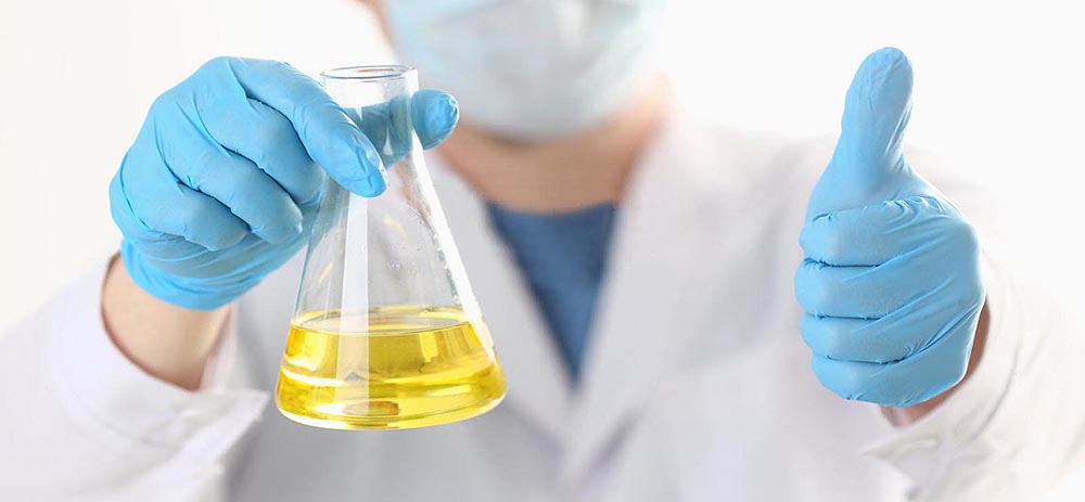 Close up of male hands in sterile gloves holding vaccine and showing approval gesture